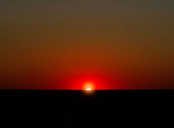 Burning sunset illuminating the horizon line background