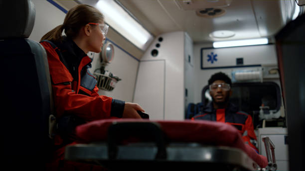 istock Medical team talking about work in emergency vehicle. Doctors driving on call 1358782403