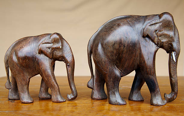 istock mother and baby elephants dark wood 135878314