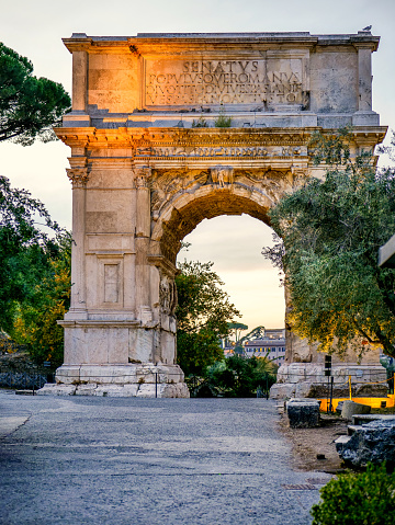 A twilight view of the stunning Arch of Titus in the Roman Forums, in the historic heart of the Eternal City. Dedicated to Titus Vespasian Augustus, this triumphal arch was built in the year 90 AD. on the northern slopes of the Palatine Hill, along the Via Sacra (Sacred Way), to celebrate the victory of Titus in the Jewish War, which ended the Jewish revolt and caused the sacking of Jerusalem. On the upper part of the arch an inscription in Latin indicates: \