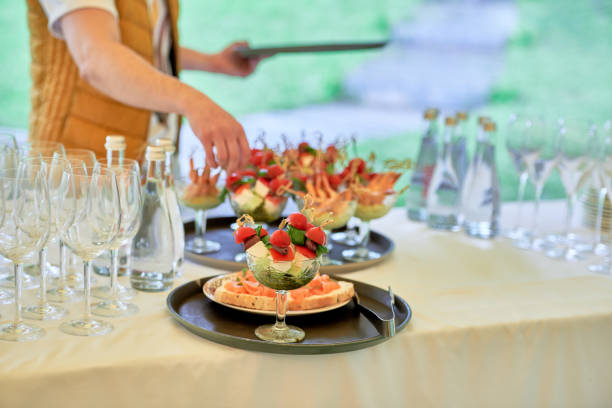istock Buffet table with snacks, canape, sandwiches and appetizers at luxury wedding reception outdoors, copy space. Serving food. Catering banquet table 1358783786