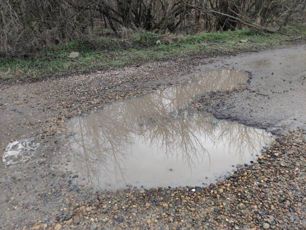 istock Big puddle on russian country road 1358783822