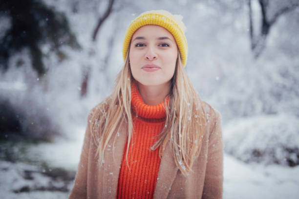 young woman enjoys cold winter day at public park