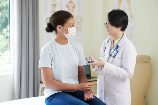 istock Doctor Explaining Advantages of Vaccine 1358785850