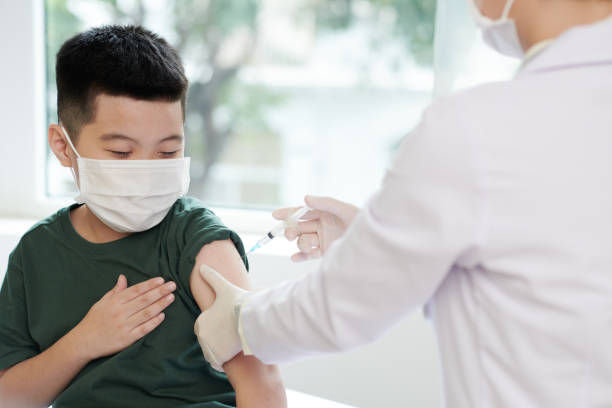 istock Little Boy Getting Vaccine in Medical Office 1358785894