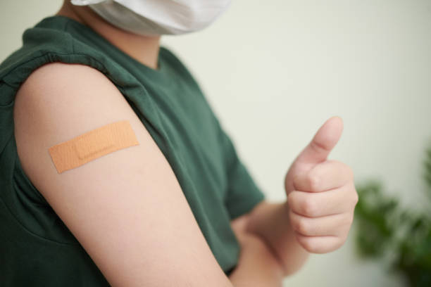istock Boy Showing Adhesive Plaster on Shoulder 1358785957