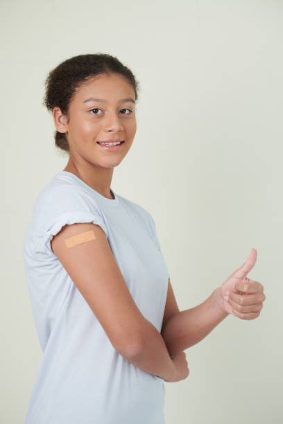 istock Vaccinated Girl Showing Thumbs-up 1358785982