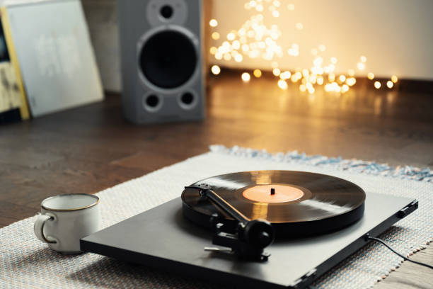 istock Turntable playing vinyl LP record at home party 1358787423