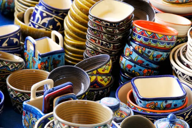 A street shop with oriental ceramics. Teapots, plates and bowls. Bowls, plates and tea cups in souvenir shop in Pune, Sale during Festival, Traditional ceramic pottery.