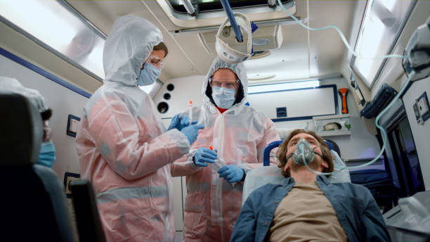 istock Multi ethnic paramedic team holding samples of coronavirus test in emergency car 1358792644
