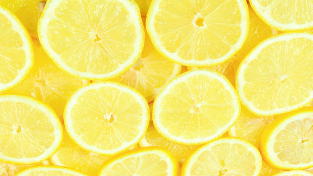 istock A slices of fresh juicy yellow lemons.  Texture background, pattern. 1358792943