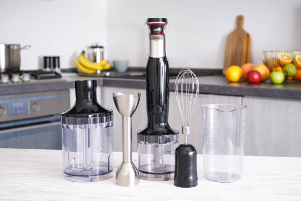 istock Electric hand mixer. Immersion hand blender on table on a kitchen background 1358795059