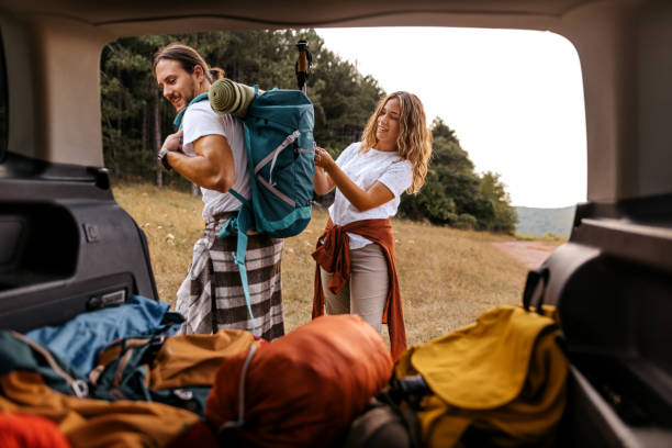istock Young couple wearing backpack for hike 1358796612