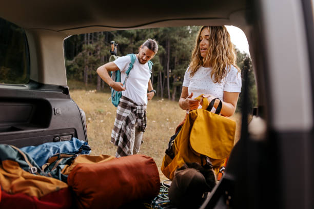 istock Young couple preparing gear for hike 1358796670
