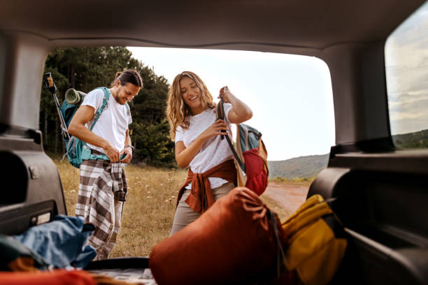 istock Young couple preparing gear for hike 1358796711
