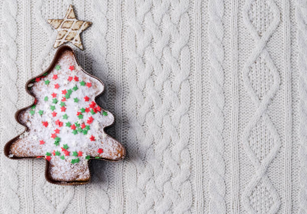 istock Christmas cupcake with decorative decoration on a knitted warm beige background with copying space, selective focus 1358796811