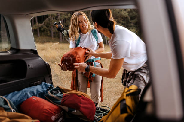 istock Young couple preparing gear for hike 1358796842