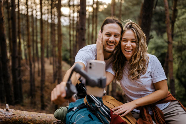 couple recording vlog during hiking using phone - resting place imagens e fotografias de stock