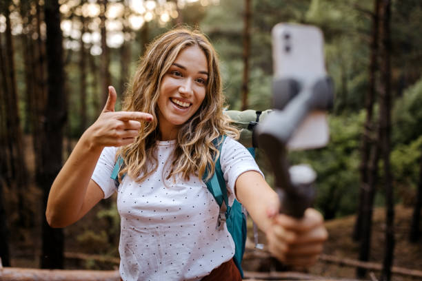 istock Young woman hiker recording vlog 1358798499