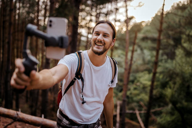 Young man hiker recording vlog