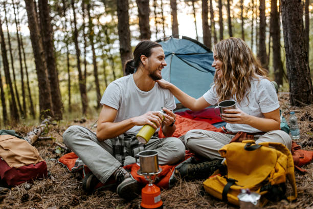 istock Young couple making coffee during hiking 1358799578