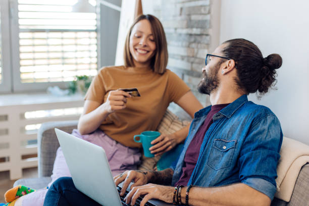 istock Couple having fun shopping online 1358799640