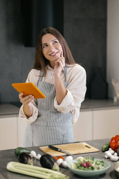 istock Young housewife looking for new cooking ideas on internet 1358800442