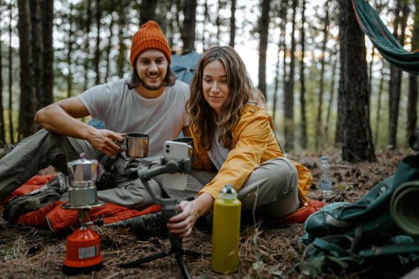 istock Happy couple drinking coffee and using smart phone 1358800452