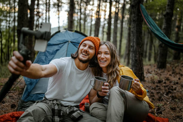 istock Happy couple drinking coffee and using smart phone 1358800646