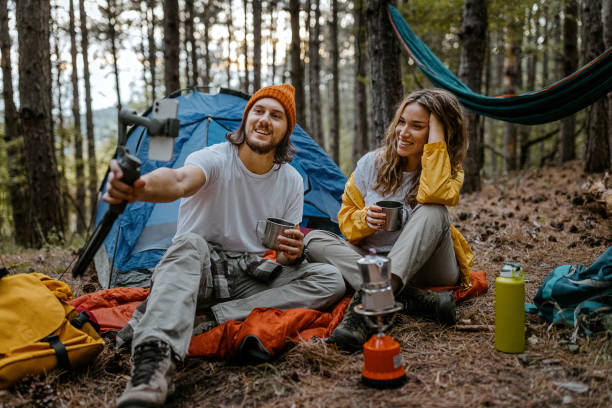 istock Happy couple drinking coffee and using smart phone 1358800753