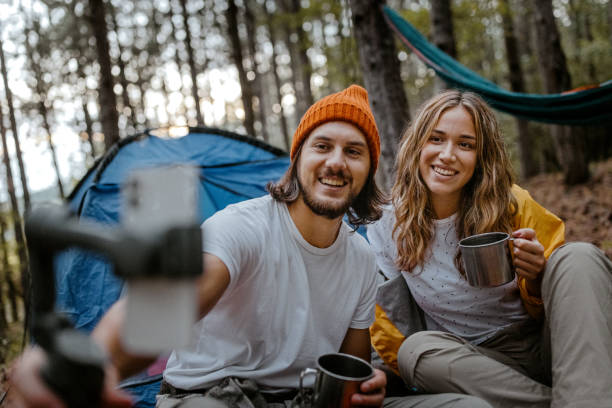 istock Happy couple drinking coffee and using smart phone 1358800797
