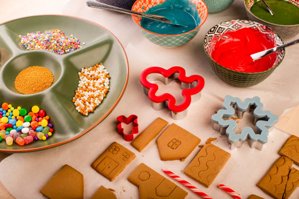 istock Gingerbread house cookies ready to be decorated with coloured royal icing. Traditional christmas family craft. 1358802497