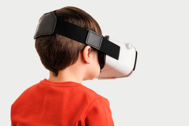 istock Cute child using virtual reality glass on white background 1358803222