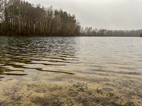 A lake in winter in rainy weather.