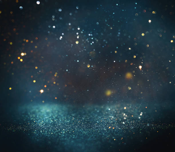 istock background of abstract glitter lights. gold, blue and black. de focused 1358803781