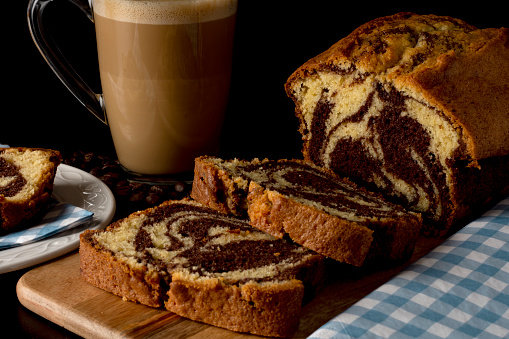 A chocolate marble cake with a cup of coffee