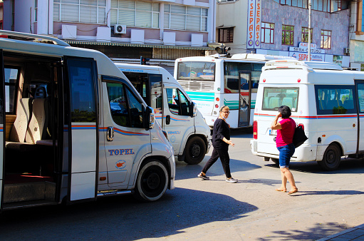 Adana, Turkey-October 10, 2021:Small buses at the bus stop. Concept of public transport and traffic in big city. This small buses are most common way to travel on short distances.
