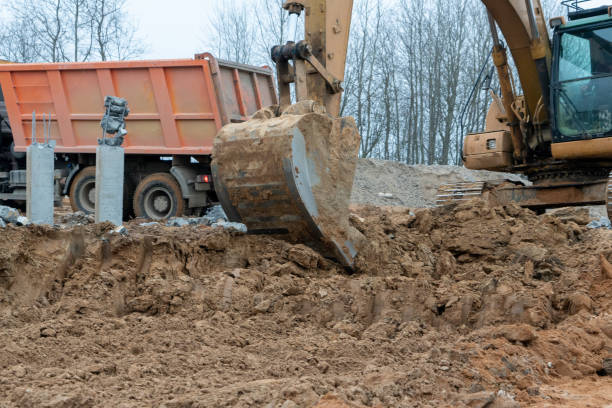 istock photo of an excavator loading sand into a dump truck 1358809033