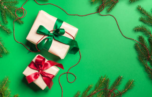 istock Two Christmas gift box on green background 1358810854