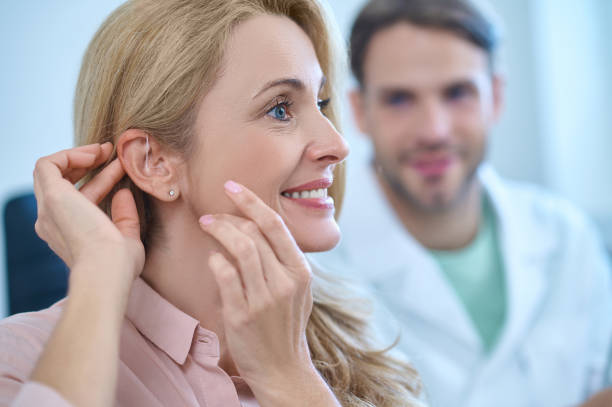 istock Profile of woman with her hands touching ear 1358811354