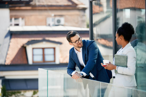 istock Business coworkers talking during their coffee break on a terrace. 1358813736