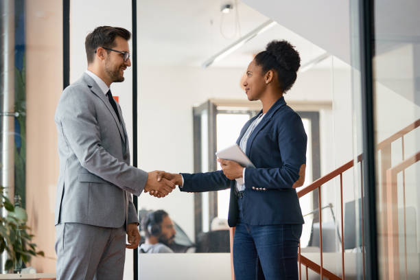 istock Happy business colleagues shaking hands in the office. 1358813852