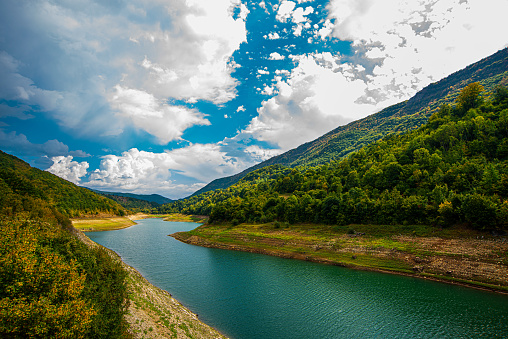 Zavojsko Lake with low water level partly due to drought and excessive discharge as well, in autumn under the blue sky and massive white clouds, Serbia, Europe