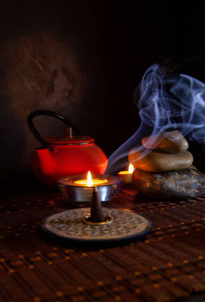 istock Incense lit next to a candle. Zen background 1358818468