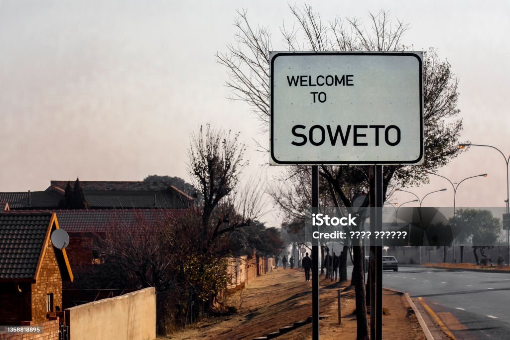 Welcome to SOWETO -  banner or road sign at the entrance of Soweto, in the suburb of Johannesburg. Welcome to SOWETO -  banner or road sign at the entrance of Soweto, in the suburb of Johannesburg. Greeting on the information road sign at the entrance to Soweto.   South Africa, Soweto Stock Photo