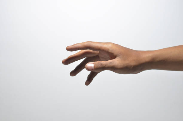 istock close-up male hand try to reaching something 1358820274