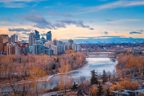 Bright Sky Over The Downtown Calgary River Valley A panoramic morning sky over the Calgary river valley in the fall. bow river stock pictures, royalty-free photos & images