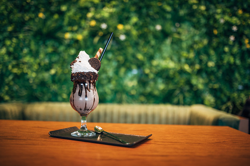 Chocolate milkshake on table inside café
