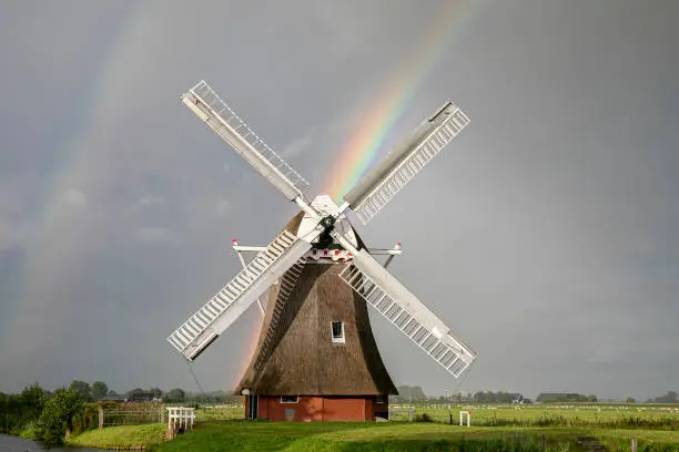 rainbow and Dutch windmill in summer, Holland