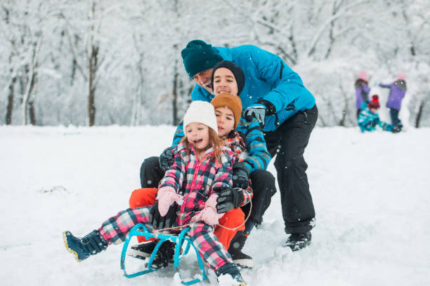 istock Grandfather with kids having good time during sledding 1358821881
